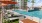 a pool with chairs and umbrellas by it
