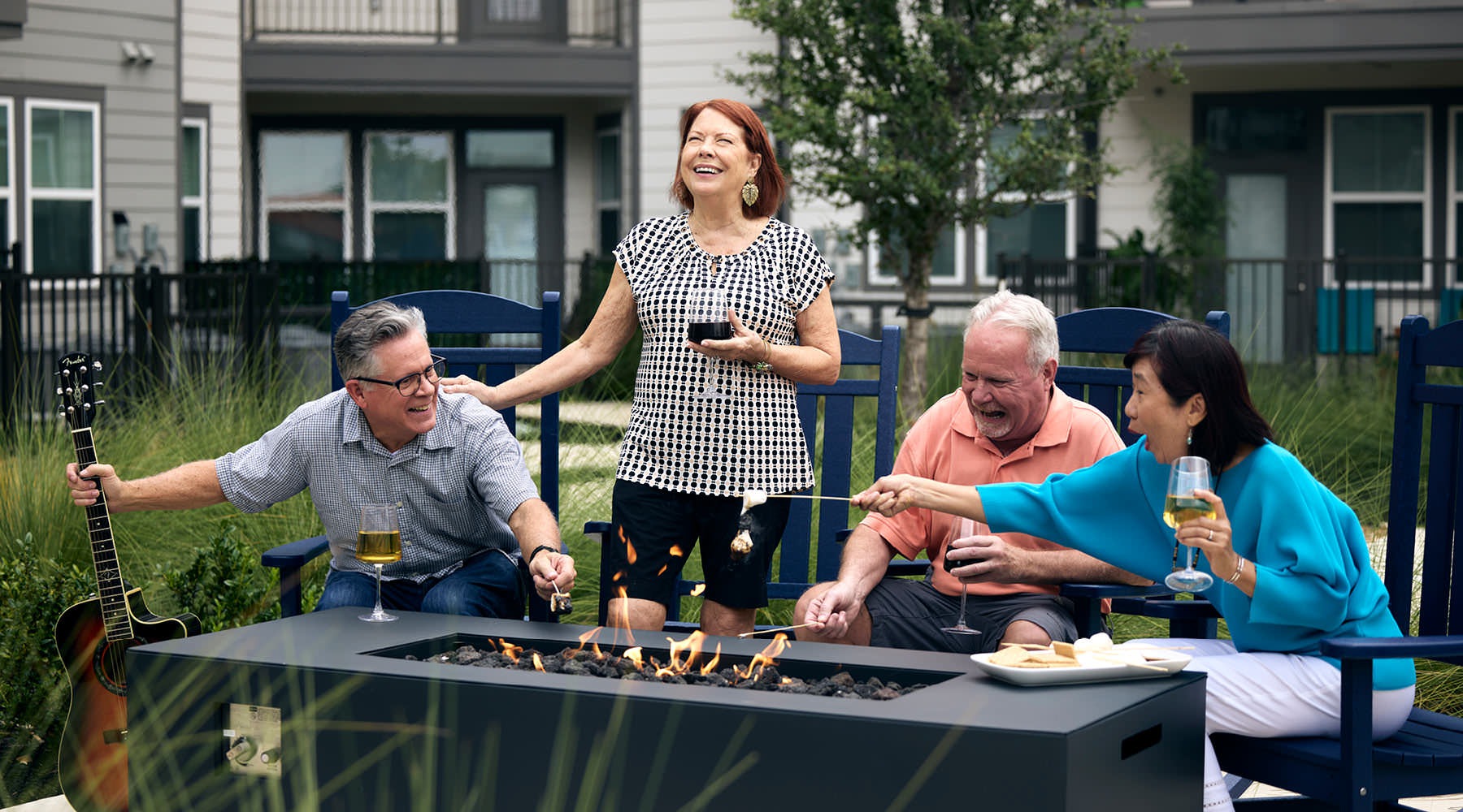 a group of people laughing around a fire